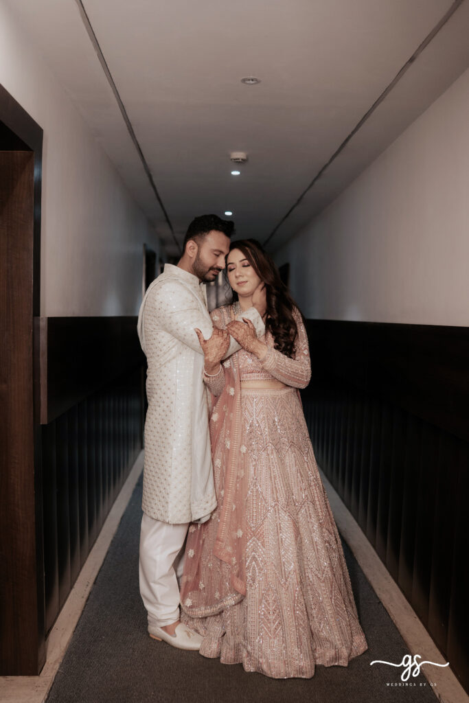 "Engaged couple sharing a romantic moment in traditional Indian attire during an indoor engagement shoot"